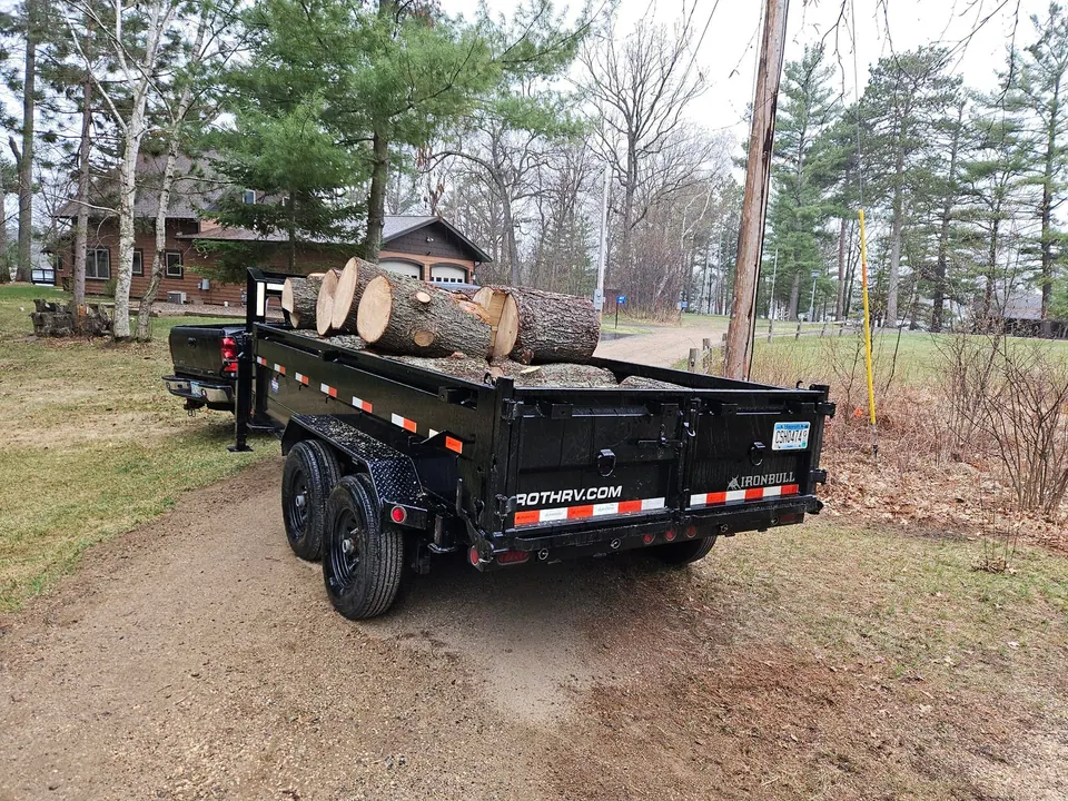 Dump trailer loaded with logs from a tree job